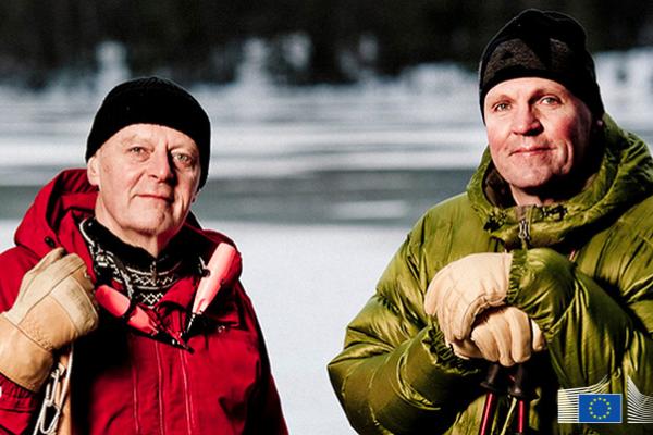 Two men outside in snow